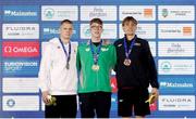 5 December 2023; Gold medallist Daniel Wiffen of Ireland, centre, with silver medallist Danas Rapsys of Lithuania, left, and bronze medallist Lucas Henveaux of Belgium after the 400m men’s freestyle during day one of the European Short Course Swimming Championships 2023 at the Aquatics Complex in Otopeni, Romania. Photo by Nikola Krstic/Sportsfile