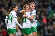 5 December 2023; Kyra Carusa of Republic of Ireland celebrates with Caitlin Hayes, right, and Heather Payne after scoring their side's third goal during the UEFA Women's Nations League B match between Northern Ireland and Republic of Ireland at the National Football Stadium at Windsor Park in Belfast. Photo by Ramsey Cardy/Sportsfile