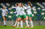 5 December 2023; Kyra Carusa of Republic of Ireland, centre, celebrates with teammates, Jamie Finn, left, and Heather Payne after scoring their third goal during the UEFA Women's Nations League B match between Northern Ireland and Republic of Ireland at the National Football Stadium at Windsor Park in Belfast. Photo by Stephen McCarthy/Sportsfile