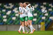 5 December 2023; Kyra Carusa of Republic of Ireland celebrates with teammates, from left, Jamie Finn, Denise O'Sullivan, hidden, and Heather Payne after scoring their side's third goal during the UEFA Women's Nations League B match between Northern Ireland and Republic of Ireland at the National Football Stadium at Windsor Park in Belfast. Photo by Stephen McCarthy/Sportsfile