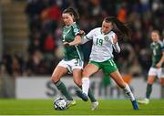 5 December 2023; Demi Vance of Northern Ireland in action against Abbie Larkin of Republic of Ireland during the UEFA Women's Nations League B match between Northern Ireland and Republic of Ireland at the National Football Stadium at Windsor Park in Belfast. Photo by Stephen McCarthy/Sportsfile