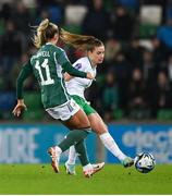 5 December 2023; Chloe Mustaki of Republic of Ireland and Danielle Maxwell of Northern Ireland during the UEFA Women's Nations League B match between Northern Ireland and Republic of Ireland at the National Football Stadium at Windsor Park in Belfast. Photo by Ramsey Cardy/Sportsfile