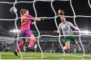5 December 2023; Kyra Carusa of Republic of Ireland scores her side's third goal past Northern Ireland goalkeeper Maddison Harvey Clifford during the UEFA Women's Nations League B match between Northern Ireland and Republic of Ireland at the National Football Stadium at Windsor Park in Belfast. Photo by Stephen McCarthy/Sportsfile