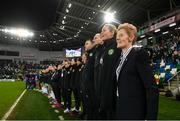 5 December 2023; Republic of Ireland interim head coach Eileen Gleeson and her coaching staff, from right, assistant coach Emma Byrne, assistant coach Colin Healy and goalkeeping coach Richie Fitzgibbon stand for the playing of the National Anthem before the UEFA Women's Nations League B match between Northern Ireland and Republic of Ireland at the National Football Stadium at Windsor Park in Belfast. Photo by Stephen McCarthy/Sportsfile