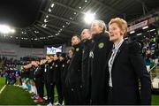 5 December 2023; Republic of Ireland interim head coach Eileen Gleeson and her coaching staff, from right, assistant coach Emma Byrne, assistant coach Colin Healy and goalkeeping coach Richie Fitzgibbon stand for the playing of the National Anthem before the UEFA Women's Nations League B match between Northern Ireland and Republic of Ireland at the National Football Stadium at Windsor Park in Belfast. Photo by Stephen McCarthy/Sportsfile