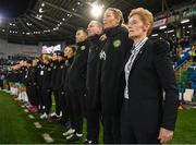 5 December 2023; Republic of Ireland interim head coach Eileen Gleeson and her coaching staff, from right, assistant coach Emma Byrne, assistant coach Colin Healy and goalkeeping coach Richie Fitzgibbon stand for the playing of the National Anthem before the UEFA Women's Nations League B match between Northern Ireland and Republic of Ireland at the National Football Stadium at Windsor Park in Belfast. Photo by Stephen McCarthy/Sportsfile