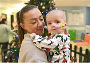 6 December 2023; Republic of Ireland's Katie McCabe with 14-month-old Zoe Mills during a visit to patients, families and staff at Children’s Health Ireland at Crumlin in Dublin. This Christmas, support can help give children & teenagers the very best chance in Children's Health Ireland at Crumlin, Temple Street, Tallaght & Connolly. Donations can be made at www.childrenshealth.ie . Photo by Stephen McCarthy/Sportsfile