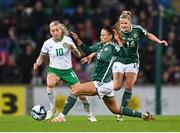 5 December 2023; Denise O'Sullivan of Republic of Ireland in action against Laura Rafferty and Nadene Caldwell, right, of Northern Ireland during the UEFA Women's Nations League B match between Northern Ireland and Republic of Ireland at the National Football Stadium at Windsor Park in Belfast. Photo by Stephen McCarthy/Sportsfile
