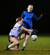 7 December 2023; Lauren Garland of UL blocks the kick of Jodi Egan of UCD during the 3rd Level Ladies Football League Division 2 final match between UCD and Ulster University at Dundalk Institute of Technology in Dundalk, Louth. Photo by Ben McShane/Sportsfile