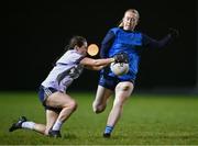 7 December 2023; Lauren Garland of UL blocks the kick of Jodi Egan of UCD during the 3rd Level Ladies Football League Division 2 final match between UCD and Ulster University at Dundalk Institute of Technology in Dundalk, Louth. Photo by Ben McShane/Sportsfile