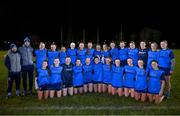 7 December 2023; UCD players, alongside manager Ian Kealy, left, and selector/coach Michael Kavanagh, second from left, with the cup after the 3rd Level Ladies Football League Division 2 final match between UCD and Ulster University at Dundalk Institute of Technology in Dundalk, Louth. Photo by Ben McShane/Sportsfile