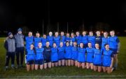 7 December 2023; UCD players, alongside manager Ian Kealy, left, and selector/coach Michael Kavanagh, second from left, with the cup after the 3rd Level Ladies Football League Division 2 final match between UCD and Ulster University at Dundalk Institute of Technology in Dundalk, Louth. Photo by Ben McShane/Sportsfile