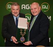 9 December 2023; Newly elected FAI president Paul Cooke, left, is presented with the presidential chains by outgoing FAI president Gerry McAnaney during the annual general meeting of the Football Association of Ireland at the Radisson Blu St. Helen's Hotel in Dublin. Photo by Stephen McCarthy/Sportsfile