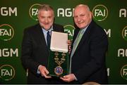 9 December 2023; Newly elected FAI president Paul Cooke, left, is presented with the presidential chains by outgoing FAI president Gerry McAnaney during the annual general meeting of the Football Association of Ireland at the Radisson Blu St. Helen's Hotel in Dublin. Photo by Stephen McCarthy/Sportsfile