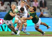 9 December 2023; Jack Kelly of Ireland is tackled by Ryan Oosthuizen and Tiaan Pretorius of South Africa during the Men's Pool A match between South Africa and Ireland during the HSBC SVNS Rugby Tournament at DHL Stadium in Cape Town, South Africa. Photo by Shaun Roy/Sportsfile