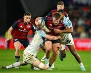 9 December 2023; Alex Nankivell of Munster is tackled by Rémi Bourdeau and Cheikh Tiberghien of Aviron Bayonnais during the Investec Champions Cup Pool 3 Round 1 match between Munster and Aviron Bayonnais at Thomond Park in Limerick. Photo by Brendan Moran/Sportsfile