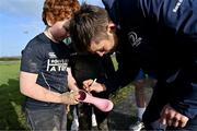 10 December 2023; As part of the club’s 12 County Tour, Leinster Rugby players Jack Conan and Ross Byrne visited Roscrea RFC for their minis’ Christmas Party. Pictured is Ross Byrne signing boots for supporter Jack Hugh at Roscrea RFC in Tipperary. Photo by Tyler Miller/Sportsfile