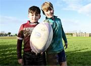 10 December 2023; As part of the club’s 12 County Tour, Leinster Rugby players Jack Conan and Ross Byrne visited Roscrea RFC for their minis’ Christmas Party. Pictured are Patrick Maher and Broady Doyle with a ball signed by Jack Conan and Ross Byrne at Roscrea RFC in Tipperary. Photo by Tyler Miller/Sportsfile