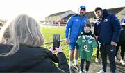 10 December 2023; As part of the club’s 12 County Tour, Leinster Rugby players Jack Conan and Ross Byrne visited Roscrea RFC for their minis’ Christmas Party. Pictured is Jack Conan and Ross Byrne taking a photograph wit supporter Kaylon Nash at Roscrea RFC in Tipperary. Photo by Tyler Miller/Sportsfile