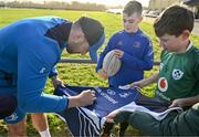 10 December 2023; As part of the club’s 12 County Tour, Leinster Rugby players Jack Conan and Ross Byrne visited Roscrea RFC for their minis’ Christmas Party. Pictured is Jack Conan signing a jersey for Jack Comerford at Roscrea RFC in Tipperary. Photo by Tyler Miller/Sportsfile
