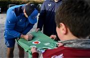 10 December 2023; As part of the club’s 12 County Tour, Leinster Rugby players Jack Conan and Ross Byrne visited Roscrea RFC for their minis’ Christmas Party. Pictured is Jack Conan signing the jersey of Sean Maloney at Roscrea RFC in Tipperary. Photo by Tyler Miller/Sportsfile