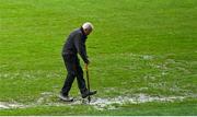 10 December 2023; A member of the groundstaff attempts to drain surface water on the pitch before the AIB Munster GAA Football Senior Club Championship Final match between Dingle, Kerry, and Castlehaven, Cork, at TUS Gaelic Grounds in Limerick. Photo by Brendan Moran/Sportsfile