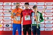 10 December 2023; Medallists, from left, Niels Laros of Netherlands, second place, Axel Vang Christensen of Denmark, first place, and Nicholas Griggs of Ireland, third place, on the podium after the U20 men's 5000m during the SPAR European Cross Country Championships at Laeken Park in Brussels, Belgium. Photo by Sam Barnes/Sportsfile