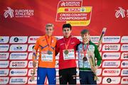 10 December 2023; Medallists, from left, Niels Laros of Netherlands, second place, Axel Vang Christensen of Denmark, first place, and Nicholas Griggs of Ireland, third place, on the podium after the U20 men's 5000m during the SPAR European Cross Country Championships at Laeken Park in Brussels, Belgium. Photo by Sam Barnes/Sportsfile