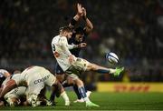 10 December 2023; Tawera Kerr-Barlow of La Rochelle kicks under pressure from Michael Ala'alatoa of Leinster during the Investec Champions Cup match between La Rochelle and Leinster at Stade Marcel Deflandre in La Rochelle, France. Photo by Harry Murphy/Sportsfile