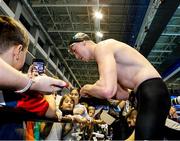 10 December 2023; Daniel Wiffen of Ireland signs autographs for fans after his victory in the Men's 800m Freestyle, setting a new world record of 7:20.46, during day six of the European Short Course Swimming Championships 2023 at the Aquatics Complex in Otopeni, Romania. Photo by Nikola Krstic/Sportsfile