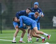 12 December 2023; Sam Prendergast is tackled by Jimmy O'Brien and Ciarán Frawley  during a Leinster Rugby squad training session at UCD in Dublin. Photo by Harry Murphy/Sportsfile