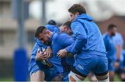 12 December 2023; Rónan Kelleher is tackled by Cian Healy and Joe McCarthy during a Leinster Rugby squad training session at UCD in Dublin. Photo by Harry Murphy/Sportsfile
