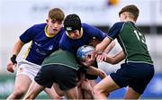 14 December 2023; Stephen Anderson of St Kevin’s Dunlavin is tackled by Archie Wakeford, left, and David Johnston of East Glendalough School during the Pat Rossiter Cup final match between East Glendalough School and St. Kevin’s Dunlavin at Energia Park in Dublin. Photo by Ben McShane/Sportsfile