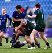 14 December 2023; Kevin Anantharajah of St Kevin’s Dunlavin is tackled by Harry Smith, left, and Stephen Duke of East Glendalough School during the Pat Rossiter Cup final match between East Glendalough School and St. Kevin’s Dunlavin at Energia Park in Dublin. Photo by Ben McShane/Sportsfile