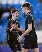 14 December 2023; David Johnston of East Glendalough School celebrates with teammate Harry Smith, left, after scoring their side's third try during the Pat Rossiter Cup final match between East Glendalough School and St. Kevin’s Dunlavin at Energia Park in Dublin. Photo by Ben McShane/Sportsfile