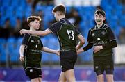 14 December 2023; David Johnston of East Glendalough School celebrates with teammates Harry Smith, right, and Alex Miley, left, after scoring their side's third try during the Pat Rossiter Cup final match between East Glendalough School and St. Kevin’s Dunlavin at Energia Park in Dublin. Photo by Ben McShane/Sportsfile