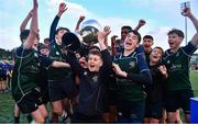 14 December 2023; Injured East Glendalough School captain Dylan Vickers lifts the cup with his teammates after the Pat Rossiter Cup final match between East Glendalough School and St. Kevin’s Dunlavin at Energia Park in Dublin. Photo by Ben McShane/Sportsfile