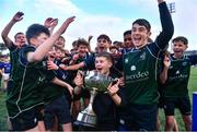 14 December 2023; Injured East Glendalough School captain Dylan Vickers lifts the cup with his teammates after the Pat Rossiter Cup final match between East Glendalough School and St. Kevin’s Dunlavin at Energia Park in Dublin. Photo by Ben McShane/Sportsfile