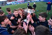 14 December 2023; Injured East Glendalough School captain Dylan Vickers, right, lifts the cup with his teammates after the Pat Rossiter Cup final match between East Glendalough School and St. Kevin’s Dunlavin at Energia Park in Dublin. Photo by Ben McShane/Sportsfile