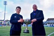 14 December 2023; Injured East Glendalough School captain Dylan Vickers is presented the cup by Pat Rossiter after the Pat Rossiter Cup final match between East Glendalough School and St. Kevin’s Dunlavin at Energia Park in Dublin. Photo by Ben McShane/Sportsfile
