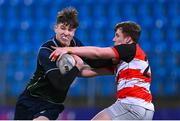 14 December 2023; James Curry of East Glendalough School is tackled by Robert William Keane of St Mary's CBS, Portlaoise, during the Anne McInerney Cup final match between St Mary's CBS, Portlaoise and East Glendalough School at Energia Park in Dublin. Photo by Ben McShane/Sportsfile