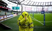 5 August 2023; A steward shelters from the rain before the Bank of Ireland Nations Series match between Ireland and Italy at the Aviva Stadium in Dublin. Photo by Harry Murphy/Sportsfile