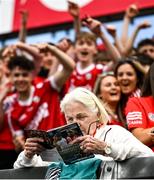 30 April 2023; A supporter in the terrace studies the match programme before the Munster GAA Hurling Senior Championship Round 2 match between Cork and Waterford at Páirc Uí Chaoimh in Cork. Photo by David Fitzgerald/Sportsfile