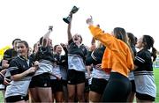 15 December 2023; The Newbridge College team celebrate with the trophy after their side's victory in the Bank of Ireland Leinster Rugby Senior Girls League match between Newbridge College and The High School at Energia Park in Dublin. Photo by Tyler Miller/Sportsfile