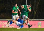 15 December 2023; Evan O’Connell of Ireland is tackled by Martino Pucciariello of Italy during the U20 international friendly match between Ireland and Italy at UCD Bowl in Dublin. Photo by Seb Daly/Sportsfile