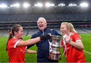 16 December 2023; Kilkerrin-Clonberne manager Willie Ward celebrates with his daughters Nicola Ward, left, and Louise Ward and the Dolores Tyrrell Memorial Cup after the Currentaccount.ie LGFA All-Ireland Senior Club Championship final match between Ballymacarby of Waterford and Kilkerrin-Clonberne of Galway at Croke Park in Dublin. Photo by Piaras Ó Mídheach/Sportsfile