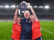 16 December 2023; Kilkerrin-Clonberne manager Willie Ward celebrates with his daughters Nicola Ward, left, and Louise Ward and the Dolores Tyrrell Memorial Cup after the Currentaccount.ie LGFA All-Ireland Senior Club Championship final match between Ballymacarby of Waterford and Kilkerrin-Clonberne of Galway at Croke Park in Dublin. Photo by Piaras Ó Mídheach/Sportsfile