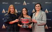 16 December 2023; In attendance during the RTÉ Sports Awards 2023 at RTÉ studios in Donnybrook, Dublin, are Cork Camogie players, from left, Laura Treacy, Amy O'Connor, and Hannah Looney, with the O'Duffy Cup. Photo by Seb Daly/Sportsfile