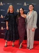 16 December 2023; In attendance during the RTÉ Sports Awards 2023 at RTÉ studios in Donnybrook, Dublin, are Cork Camogie players, from left, Laura Treacy, Amy O'Connor, and Hannah Looney, with the O'Duffy Cup. Photo by Seb Daly/Sportsfile