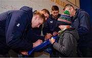 16 December 2023; Leinster players from left, Jamie Osborne, Scott Penny and Ross Byrne sign  autographs in autograph alley before the Investec Champions Cup Pool 4 Round 2 match between Leinster and Sale Sharks at the RDS Arena in Dublin. Photo by Sam Barnes/Sportsfile